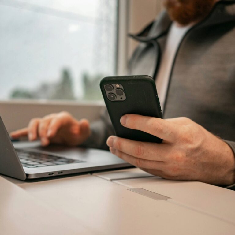 Remote professional multitasking on laptop and smartphone, illustrating real-time mobile threat response. A powerful representation of Checktxt vs. Threat Intelligence platforms (Flare, Recorded Future), emphasizing direct protection over passive reporting. Essential for US enterprises and MSSPs needing actionable results and immediate response with 60-second analysis. Checktxt delivers proactive takedowns that eliminate threats instantly rather than just reporting them. #Checktxt #ThreatIntelligence #ActiveDefense #Cybersecurity #MSSP #FlareAlternative #RecordedFutureAlternative #ProactiveSecurity #UnitedStates