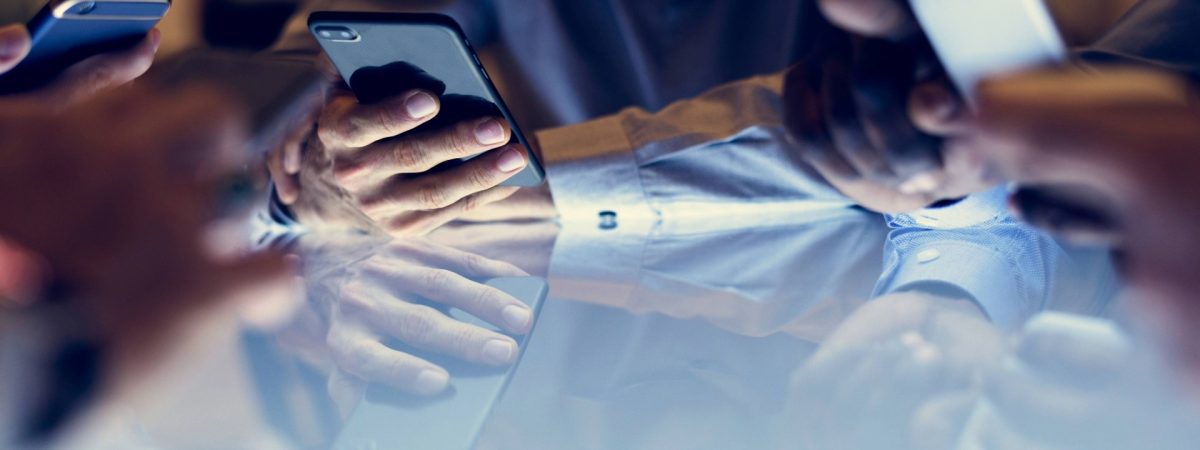 Multiple hands interacting with smartphones around a reflective table, symbolizing widespread mobile communication and digital engagement. Essential for enterprises, MSSPs, developers, and product managers in the United States addressing SMS security and verification challenges. Explore Checktxt for robust text message analysis and protection. #Checktxt #MobileCommunication #SMSVerification #EnterpriseSolutions #DigitalEngagement #TextSecurity #MSSP #Developers #ProductManagement #CustomerSupport #UnitedStates