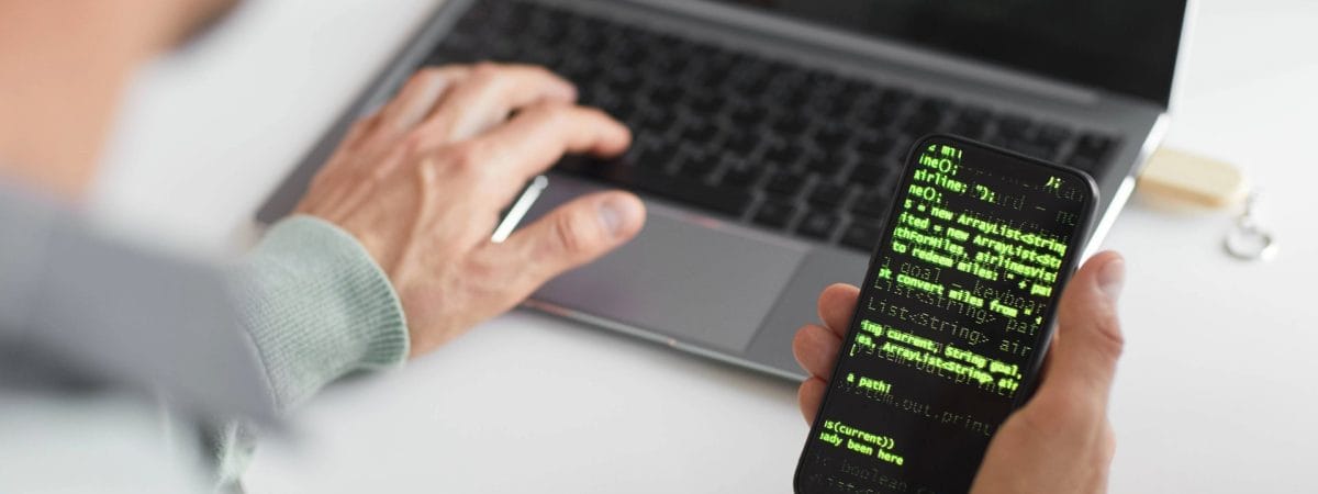 Developer actively coding on a laptop and reviewing code on a smartphone, illustrating mobile development and technical analysis. Essential for developers, programmers, and IT professionals in the United States seeking advanced text verification and secure SMS solutions. Explore Checktxt for powerful text data processing. #Checktxt #MobileDevelopment #Coding #Programming #TextAnalysis #SMSVerification #Developers #ITProfessionals #EnterpriseSolutions #UnitedStates